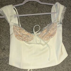 White cropped corset like top with lace. Never been worn, no tag.